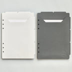 Light and dark gray planner dividers on a light gray background