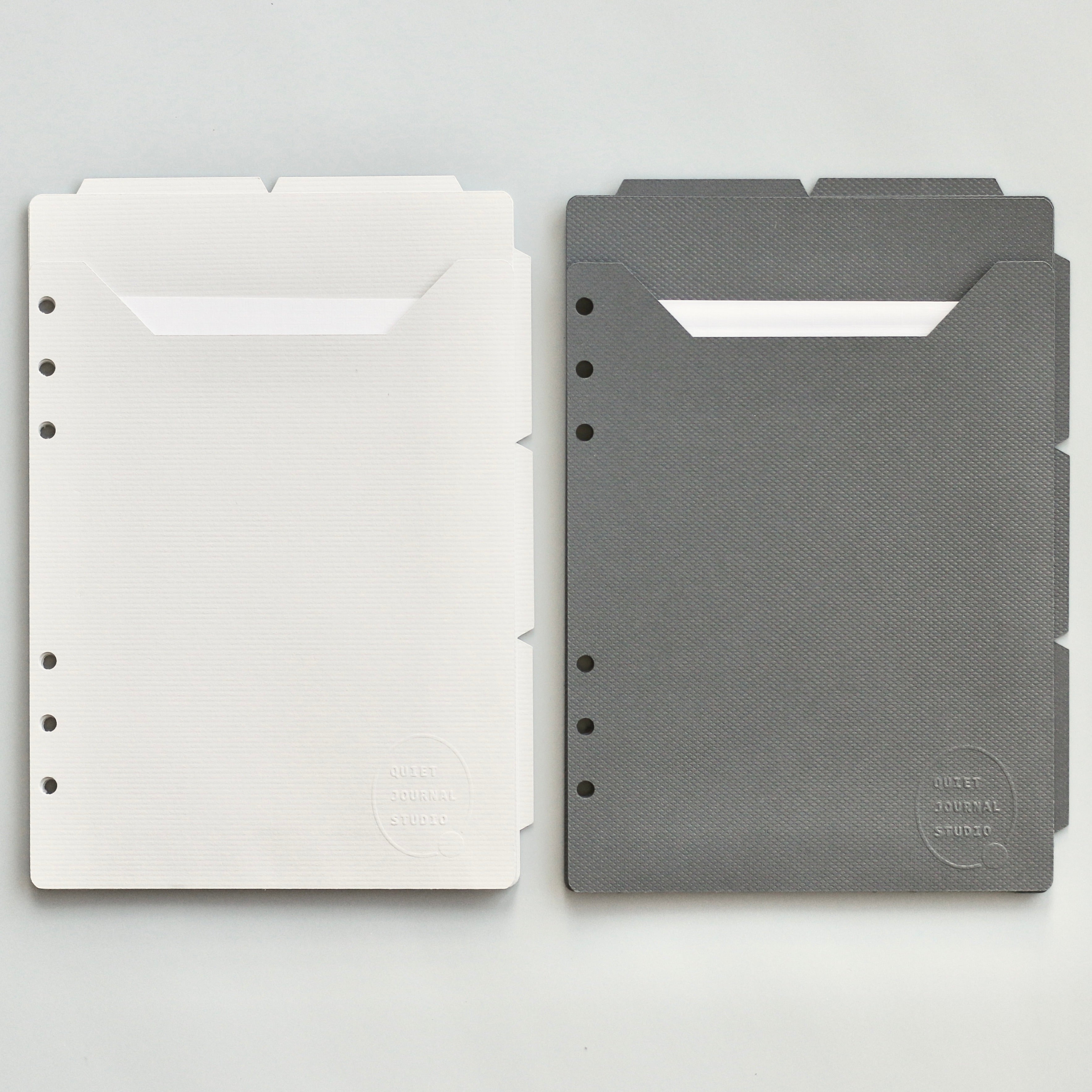 Light and dark gray planner dividers on a light gray background