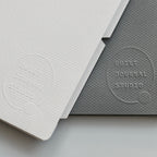 Two dividers, one light gray and one dark gray, with 'Quiet Journal Studio' embossed on them, on a light gray background.