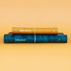Two books, one ribbon-bound and one 6-ring bound, on a beige background.