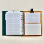 Open planner with different page designs on a white background