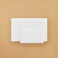 Two white annual tracker stickers on a beige background
