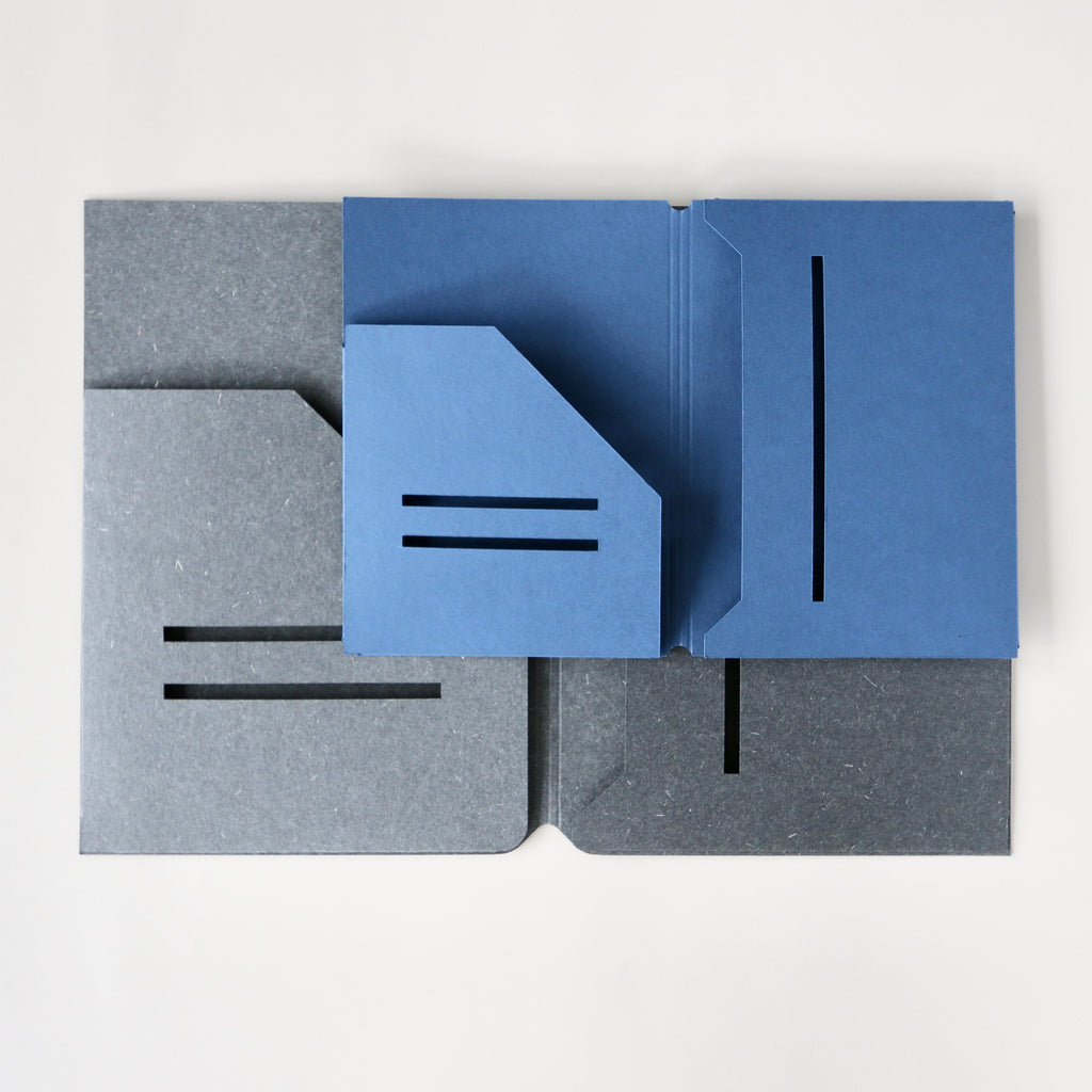 Two blue and gray journal pocket folders on a white background