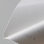 Close-up of a white paper with text on a light gray background