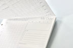 Planner with daily schedule on a white surface