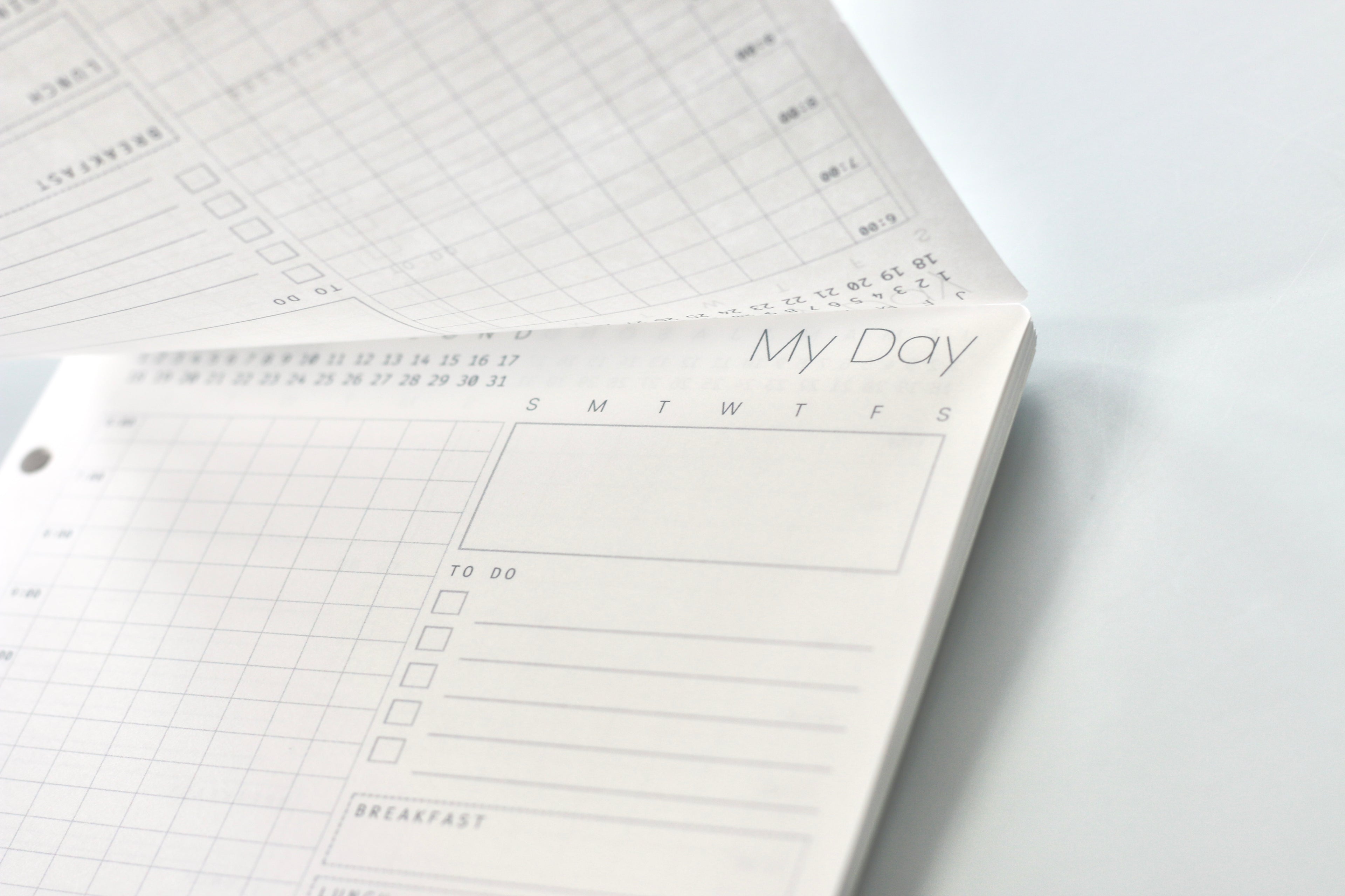 Planner with daily schedule on a white surface