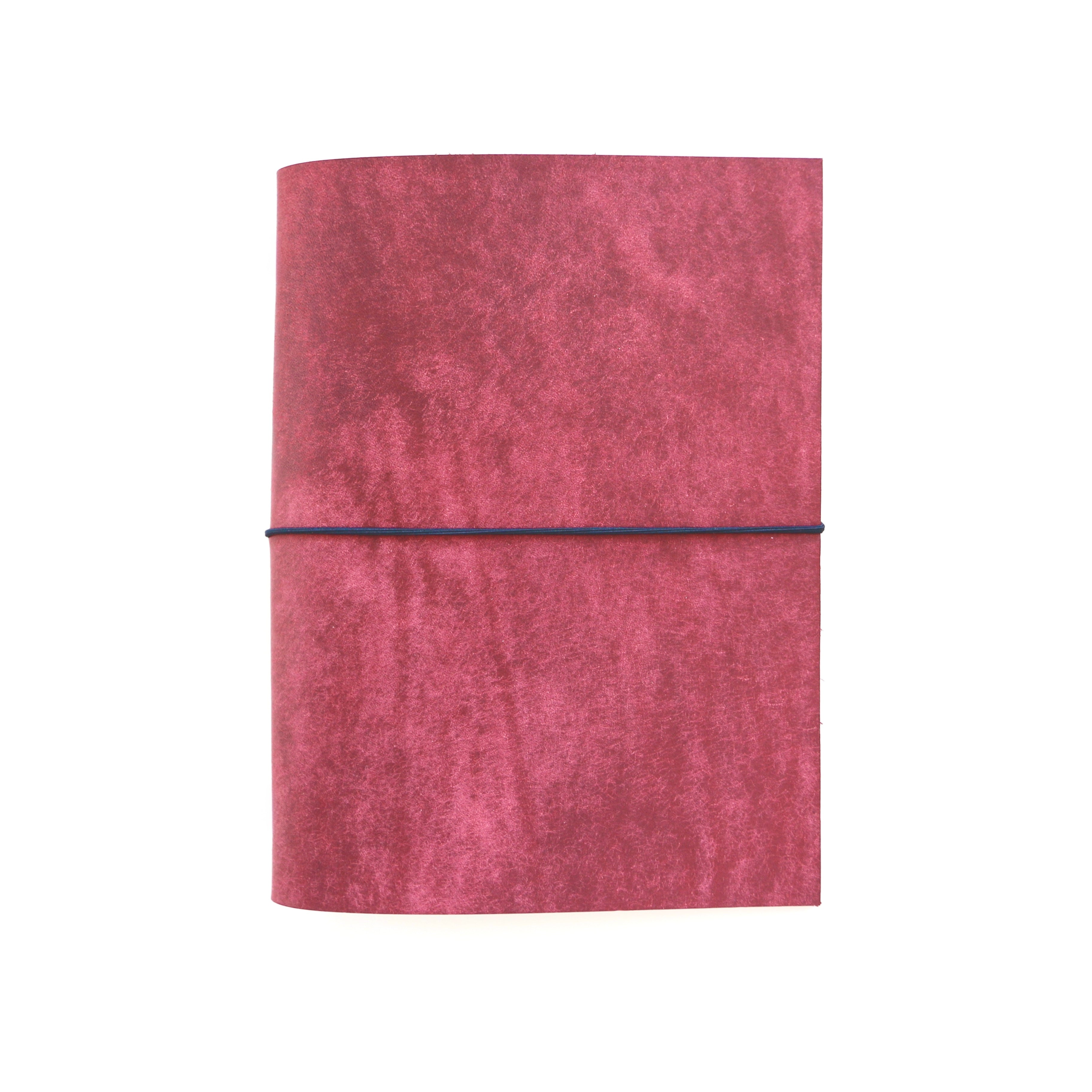 Red notebook with a black elastic band on a white background