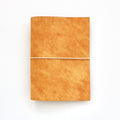 Yellow leather notebook on a white background