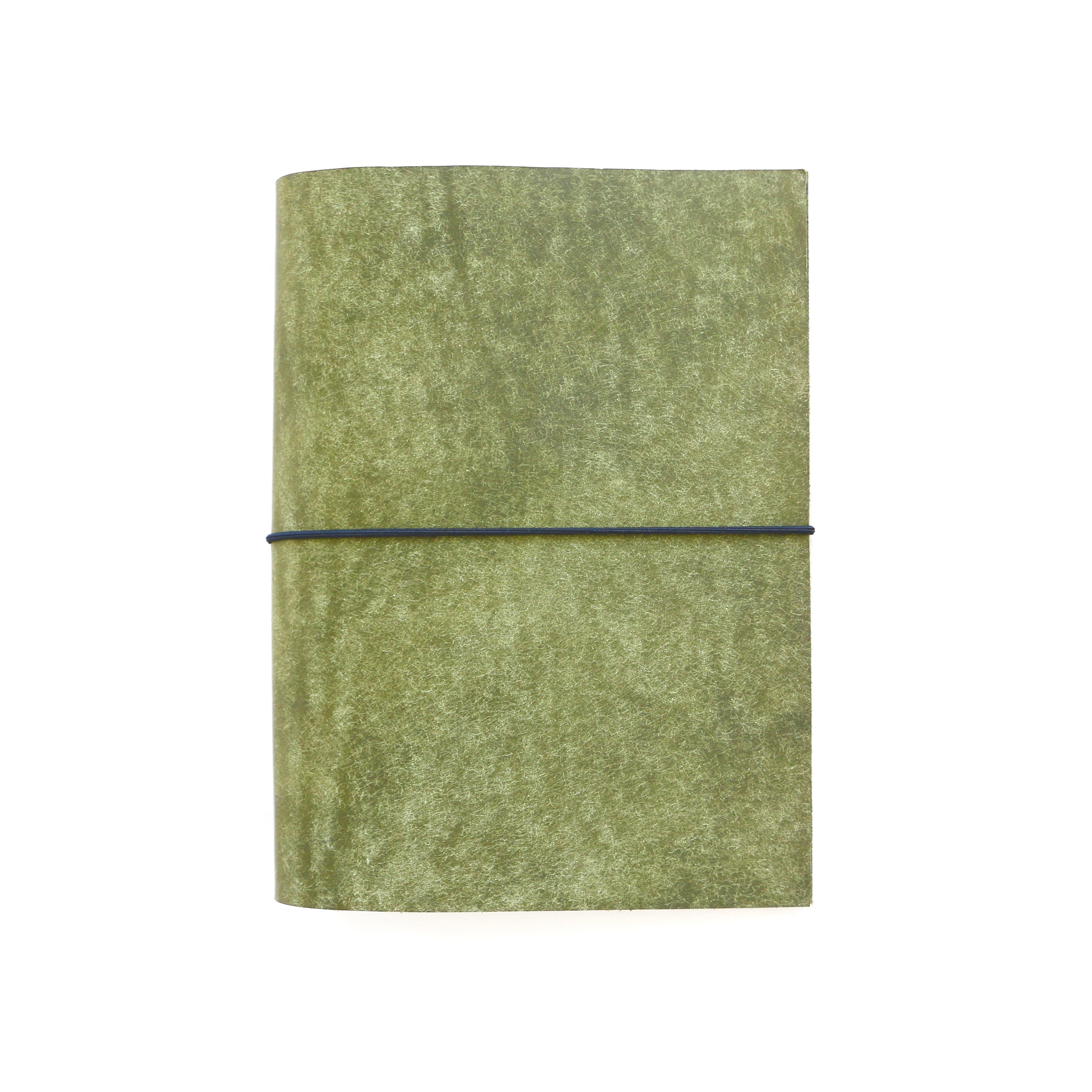 Green textured notebook with a black elastic band on a white background
