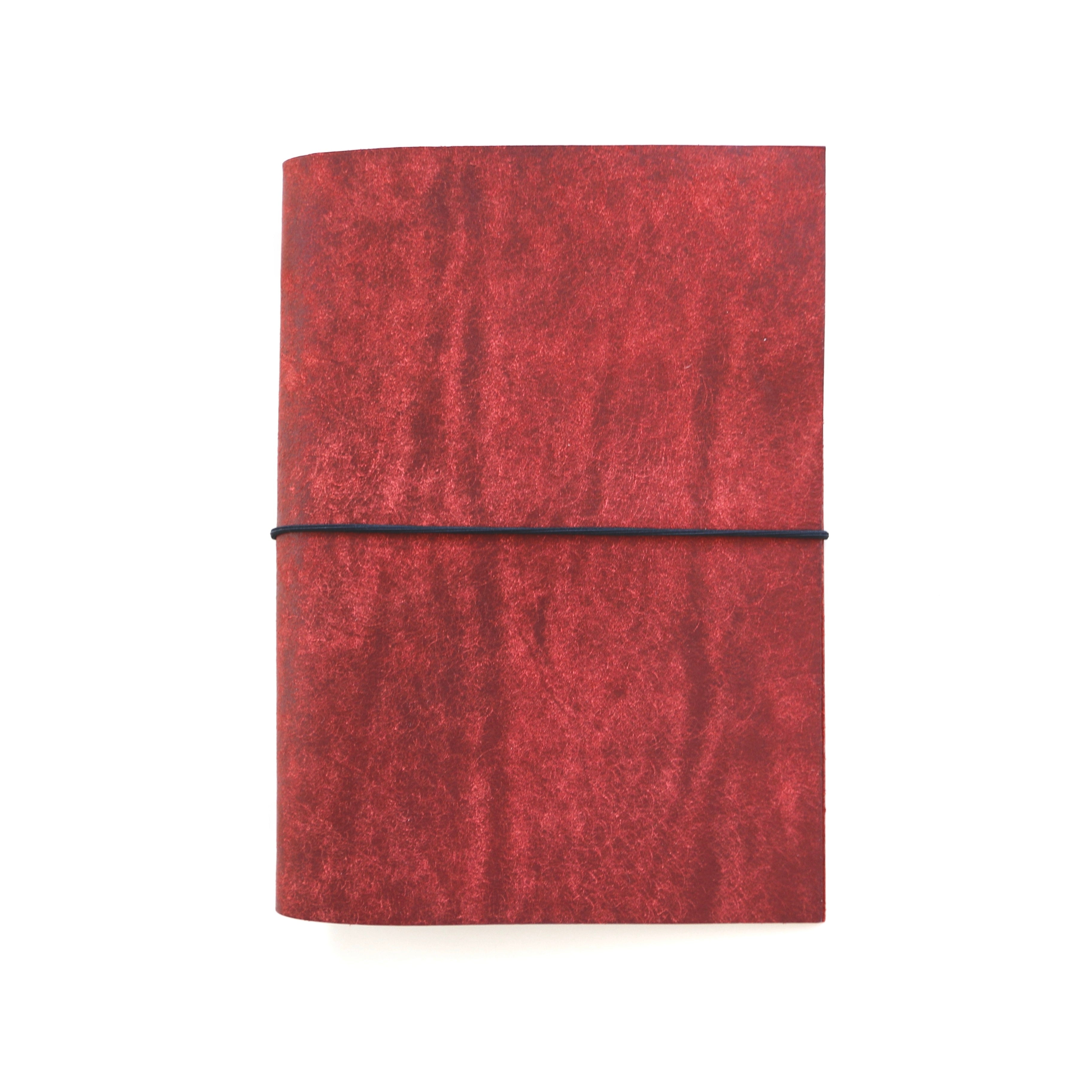 Red leather notebook on a white background