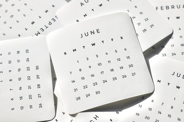 Calendar pages with June on a background of other calendar pages.